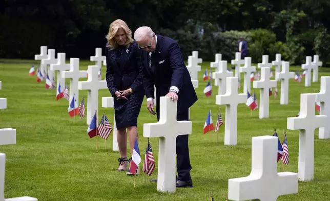 THE GRAVE SHOWN MAY NOT BE PRIVATE FIRST CLASS JOHN GREENFIELD'S GRAVE - President Joe Biden and first lady Jill Biden, visit the graves at the Normandy American Cemetery after a ceremony to mark the 80th anniversary of D-Day, Thursday, June 6, 2024, in Normandy. (AP Photo/Evan Vucci)