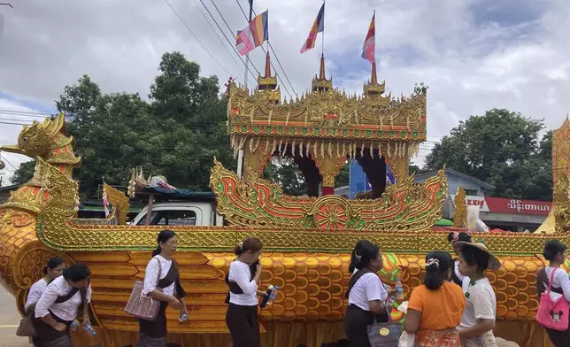 CORRECTS THE COFFIN IS NOT INSIDE THE VEHICLE - A vehicle with an elaborate design as a traditional Karaweik vessel is prepared to carry the coffin of the late monk Bhaddanta Munindarbhivamsa in a funeral cortege to be cremated in Bago, Myanmar, Thursday, June 27, 2024. The senior monk was shot dead last week by soldiers who the military government said mistaked the vehicle in which he was traveling for a security threat. (AP Photo)