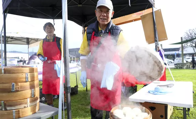CORRECTING FIRST LINE- Alice, left, and Shuxiong Zheng make steamed buns during Matariki Whanau Day at the Wainuiomata Community Hub in Wellington, New Zealand on June 22, 2024. Now in its third year as a nationwide public holiday in New Zealand, Matariki marks the lunar new year by the rise of the star cluster known in the Northern Hemisphere as the Pleiades. (AP Photo/Hagen Hopkins)