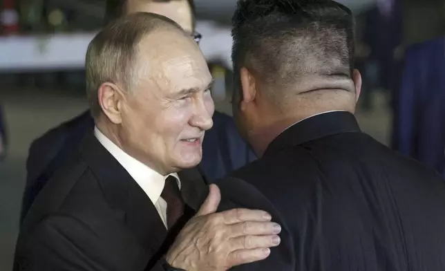 CORRECTS DATE TO EARLY WEDNESDAY, JUNE 19 - Russian President Vladimir Putin, left, and North Korea's leader Kim Jong Un greet each other during their meeting at the Pyongyang Sunan International Airport outside Pyongyang, North Korea, early Wednesday, June 19, 2024. (Gavriil Grigorov, Sputnik, Kremlin Pool Photo via AP)