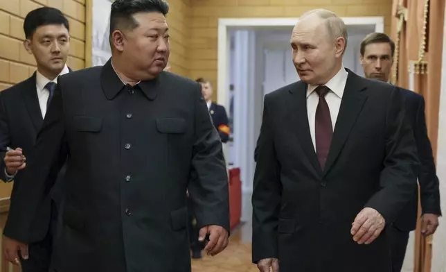 CORRECTS DATE TO EARLY WEDNESDAY, JUNE 19 - Russian President Vladimir Putin, right, and North Korea's leader Kim Jong Un talk to each other during their meeting in Pyongyang, North Korea, early Wednesday, June 19, 2024. (Gavriil Grigorov, Sputnik, Kremlin Pool Photo via AP)