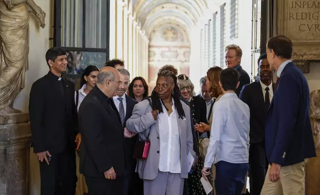 CAPTION CORRECTS LOCATION Whoopi Goldberg, centre, arrives for an audience with Pope Francis in the Clementine Hall at The Vatican, Friday, June 14, 2024. Pope Francis is meeting with over 100 comedians from 15 countries aiming to establish a link between the Catholic Church and comic artists. (AP Photo/Riccardo De Luca)