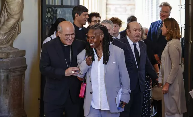 CAPTION CORRECTS LOCATION Whoopi Goldberg, centre, leaves after an audience with Pope Francis in Clementine Hall, at The Vatican, Friday, June 14, 2024. Pope Francis is meeting with over 100 comedians from 15 countries aiming to establish a link between the Catholic Church and comic artists. (AP Photo/Riccardo De Luca)