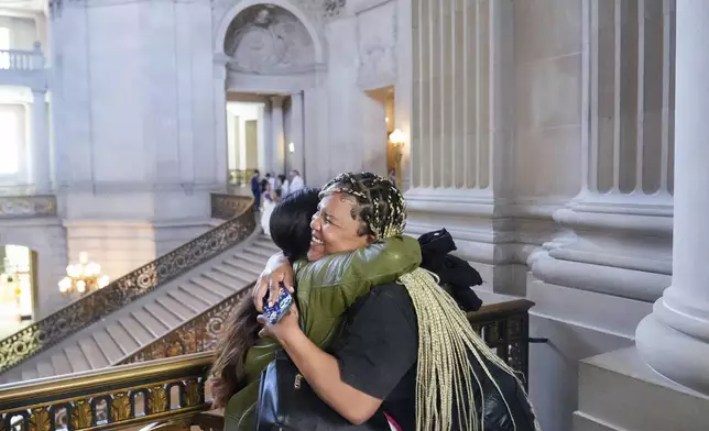 Danica Gutierrez, left, and Christiana Porter hug after they met with politicians at City Hall, Tuesday, May 21, 2024, in San Francisco. Gutierrez, Porter and six other women are part of Family Advisory Committee, a pilot program by San Francisco nonprofit Compass Family Services, working to engage more homeless parents in advocacy as family homelessness surges in the U.S. (AP Photo/Godofredo A. Vásquez)