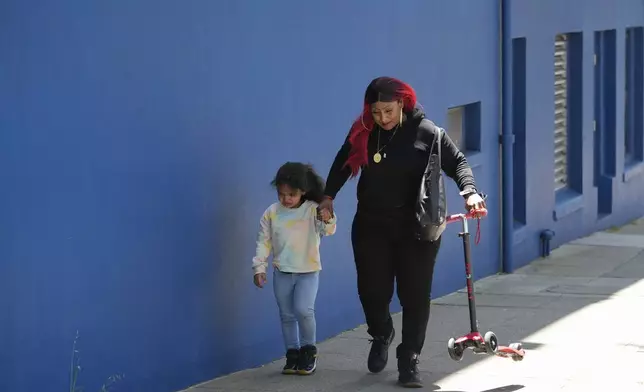 Teniah Tercero, right, walks with her daughter Valentina, 4, after playing with the family's scooter Thursday, May 23, 2024, in San Francisco. (AP Photo/Godofredo A. Vásquez)