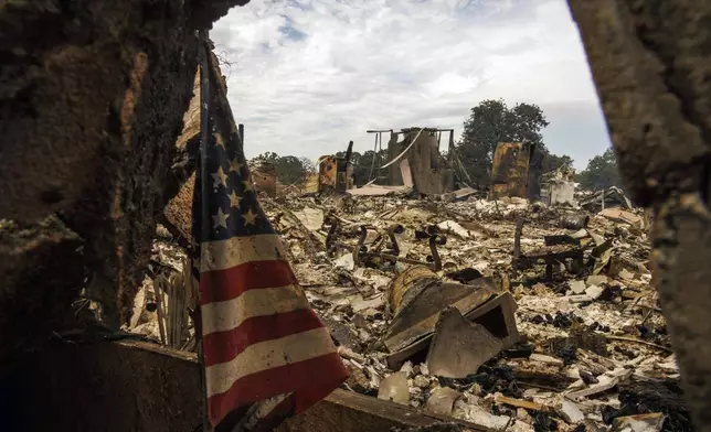 The remains of a structure destroyed by the Apache Fire as it burns in Palermo, Calif., on Tuesday, Jun. 25, 2024.According to Cal Fire, more than a dozen new fires sparked by lightning. (AP Photo/Ethan Swope)