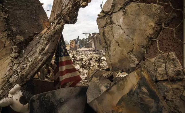 The remains of a structure destroyed by the Apache Fire as it burns in Palermo, Calif., on Tuesday, Jun. 25, 2024. According to Cal Fire, more than a dozen new fires sparked by lightning. (AP Photo/Ethan Swope)