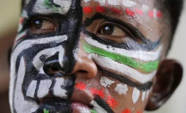 A man, his face painted in the likeness of a spirit, participates in the He Neak Ta rituals in Phum Boeung village, northwest of Phnom Penh, Cambodia, Tuesday, June 11, 2024. Cambodian villagers on Tuesday took part in a rare traditional guardian spirit ceremony praying for good fortune, rain and prosperity, as they aimed to preserve this ancient tradition. (AP Photo/Heng Sinith)