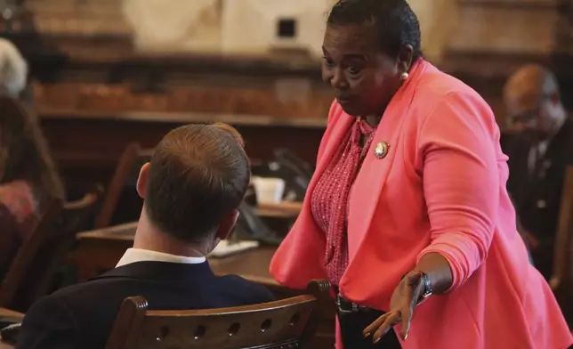 Kansas state Sen. Oletha Faust-Goudeau, right, D-Wichita, confers with Sen. Ethan Corson, left, D-Prairie Village, during a Senate debate on a proposal aimed at luring the Super Bowl champion Kansas City Chiefs from Missouri, Tuesday, June 18, 2024, at the Statehouse in Topeka, Kansas. The measure would allow Kansas to issue bonds to help the Chiefs and professional baseball's Kansas City Royals new stadiums in Kansas. (AP Photo/John Hanna)