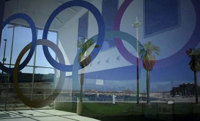 FILE - The Olympic rings are visible at the Roucas Blanc Marina constructed for the upcoming summer Olympic Games in Marseille, southern France, Tuesday, April 2, 2024. Marseille will host the Olympic sailing events during the Paris 2024 Olympic Games that run from July 26 to Aug.11, 2024. (AP Photo/Daniel Cole, File)