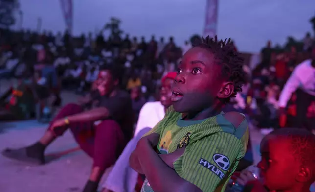 A young spectator looks at a dance performance in Goma, Democratic Republic of the Congo, Saturday, June 15, 2024, during the annual Goma Dance Festival. (AP Photo/Moses Sawasawa)