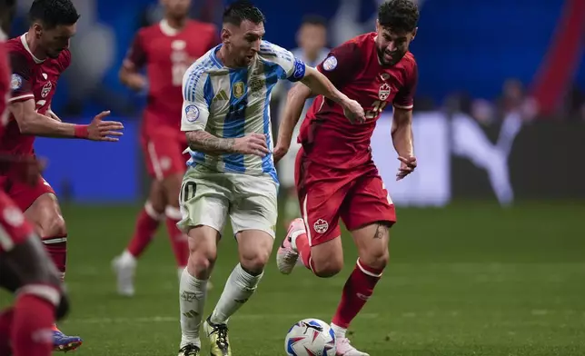 Argentina's Lionel Messi, 10, and Canada's Jonathan Osorio battle for the ball during a Copa America Group A soccer match in Atlanta, Thursday, June 20, 2024. (AP Photo/Mike Stewart)