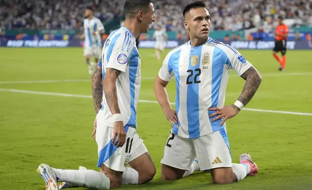 Argentina's Lautaro Martínez (22) celebrates scoring his side's opening goal against Peru with teammate Angel Di Maria during a Copa America Group A soccer match in Miami Gardens, Fla., Saturday, June 29, 2024. (AP Photo/Lynne Sladky)