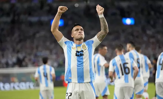 Argentina's Lautaro Martínez celebrates scoring his side's opening goal against Peru during a Copa America Group A soccer match in Miami Gardens, Fla., Saturday, June 29, 2024. (AP Photo/Lynne Sladky)