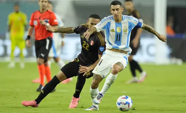 Argentina's Angel Di Maria (11) and Peru's Alexander Callens battle for the ball during a Copa America Group A soccer match in Miami Gardens, Fla., Saturday, June 29, 2024. (AP Photo/Rebecca Blackwell)