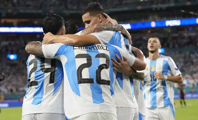 Argentina's Lautaro Martínez (22) celebrates scoring his side's second goal against Peru with teammates during a Copa America Group A soccer match in Miami Gardens, Fla., Saturday, June 29, 2024.(AP Photo/Lynne Sladky)