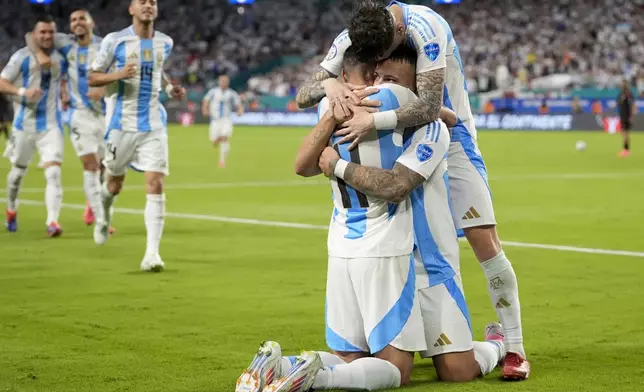 Argentina's Lautaro Martínez, center, celebrates scoring his side's opening goal against Peru teammates during a Copa America Group A soccer match in Miami Gardens, Fla., Saturday, June 29, 2024. (AP Photo/Lynne Sladky)