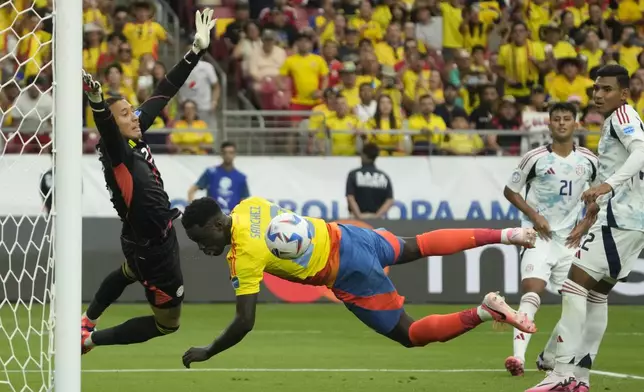 Costa Rica's goalkeeper Patrick Sequeira, left, stops a shot by Colombia's Davinson Sanchez during a Copa America Group D soccer match in Glendale, Ariz., Friday, June 28, 2024. (AP Photo/Rick Scuteri)