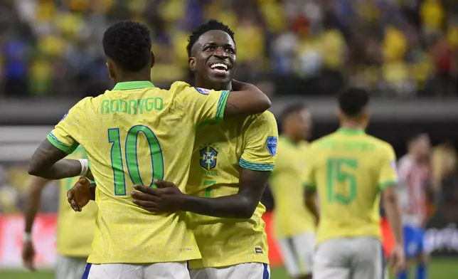 Brazil's Vinicius Junior, right, celebrates with teammate Rodrygo after scoring his side's third goal during a Copa America Group D soccer match against Paraguay, in Las Vegas, Friday, June 28, 2024. (AP Photo/David Becker)