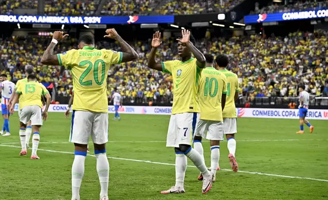Brazil's Savinho (20) celebrates scoring his side's second goal against Paraguay with teammate Vinicius Junior during a Copa America Group D soccer match in Las Vegas, Friday, June 28, 2024. (AP Photo/David Becker)