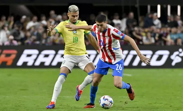 Brazil's Andreas Pereira, left, and Paraguay's Hernesto Caballero fight for the ball during a Copa America Group D soccer match in Las Vegas, Friday, June 28, 2024. (AP Photo/David Becker)