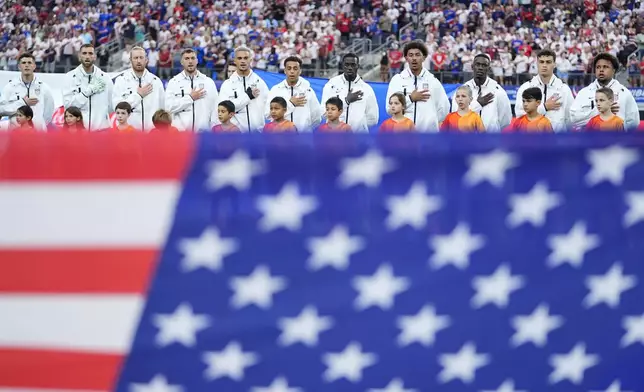 Players of United States stand during the national anthem prior to a Copa America Group C soccer match against Bolivia in Arlington, Texas, Sunday, June 23, 2024. (AP Photo/Julio Cortez)