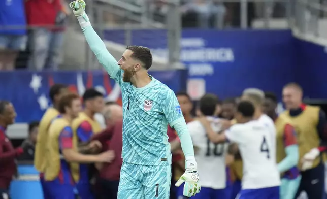 Goalkeeper Matt Turner of the United States celebrates his side's opening goal against Bolivia scored by teammate Christian Pulisic during a Copa America Group C soccer match in Arlington, Texas, Sunday, June 23, 2024. (AP Photo/Julio Cortez)