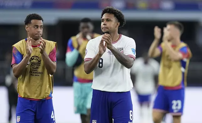 Weston McKennie of the United States and teammates celebrate their team's 2-0 victory over Bolivia at the end of a Copa America Group C soccer match in Arlington, Texas, Sunday, June 23, 2024. (AP Photo/Tony Gutierrez)