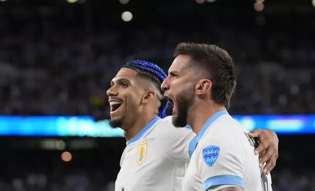 Uruguay's Rodrigo Bentancur, right, celebrates with teammate Ronald Araujo after scoring his side's fifth goal against Bolivia during a Copa America Group C soccer match in East Rutherford, N.J., Thursday, June 27, 2024. (AP Photo/Julia Nikhinson)