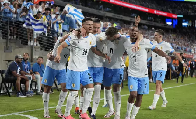 Uruguay's Maximiliano Araujo, left, celebrates with teammates after scoring his side's third goal against Bolivia during a Copa America Group C soccer match in East Rutherford, N.J., Thursday, June 27, 2024. (AP Photo/Julia Nikhinson)