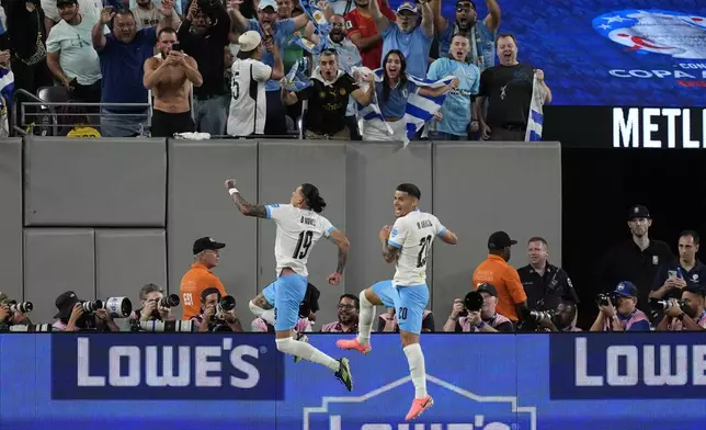 Uruguay's Darwin Nunez, left, celebrates after scoring his side's 2nd goal against Bolivia during a Copa America Group C soccer match in East Rutherford, N.J., Thursday, June 27, 2024. (AP Photo/Julia Nikhinson)