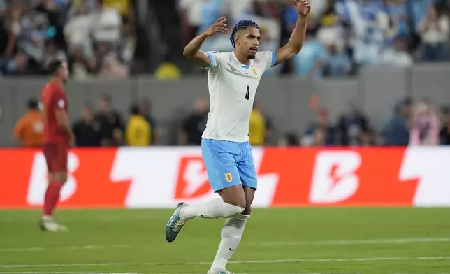 Uruguay's Ronald Araujo celebrates his side's opening goal against Bolivia scored by teammate Facundo Pellistri during a Copa America Group C soccer match in East Rutherford, N.J., Thursday, June 27, 2024. (AP Photo/Julia Nikhinson)