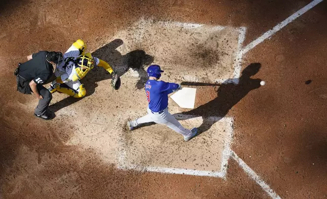 Chicago Cubs' Ian Happ, right, hits a two-run home run during the eighth inning of a baseball game against the Milwaukee Brewers, Saturday, June 29, 2024, in Milwaukee. (AP Photo/Aaron Gash)