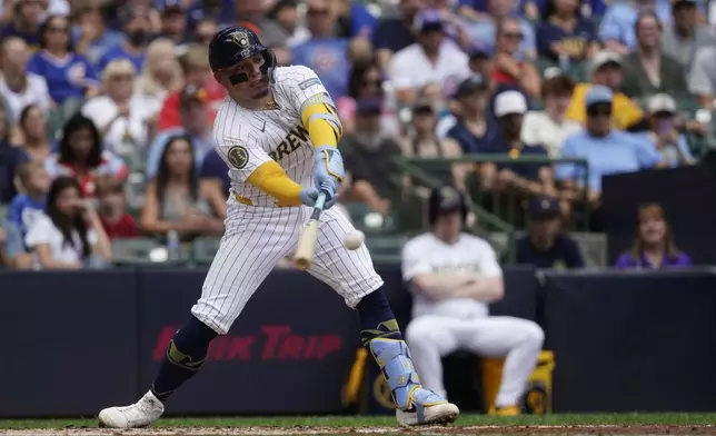 Milwaukee Brewers' William Contreras hits an RBI single during the third inning of a baseball game against the Chicago Cubs, Saturday, June 29, 2024, in Milwaukee. (AP Photo/Aaron Gash)