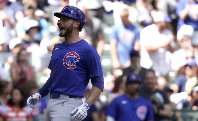 Chicago Cubs' Michael Busch reacts as he crosses home plate after hitting a two-run home run during the first inning of a baseball game against the Milwaukee Brewers, Saturday, June 29, 2024, in Milwaukee. (AP Photo/Aaron Gash)