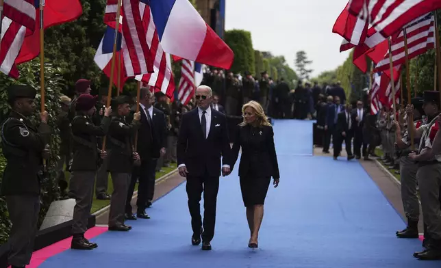 President Joe Biden and First Lady Jill Biden leave after a commemorative ceremony to mark D-Day 80th anniversary, Thursday, June 6, 2024 at the US cemetery in Colleville-sur-Mer, Normandy. Normandy is hosting various events to officially commemorate the 80th anniversary of the D-Day landings that took place on June 6, 1944. (AP Photo/Daniel Cole, Pool)