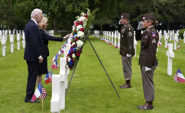 President Joe Biden and first lady Jill Biden stand before a wreath at the Normandy American Cemetery following a ceremony to mark the 80th anniversary of D-Day, Thursday, June 6, 2024, in Normandy. (AP Photo/Evan Vucci)