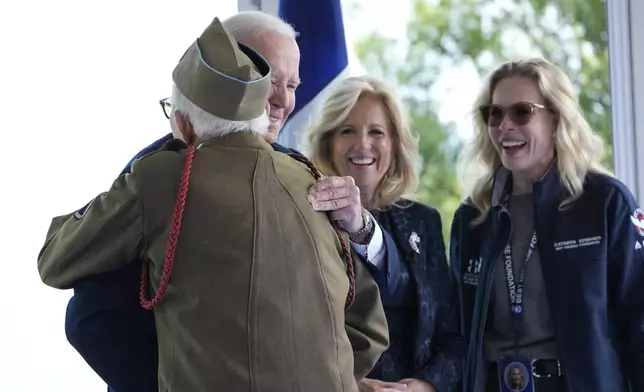 President Joe Biden and first lady Jill Biden, greet a World War II veteran during ceremonies to mark the 80th anniversary of D-Day, Thursday, June 6, 2024, in Normandy. (AP Photo/Evan Vucci)