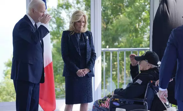 President Joe Biden and first lady Jill Biden, greet a World War II veteran during ceremonies to mark the 80th anniversary of D-Day, Thursday, June 6, 2024, in Normandy. (AP Photo/Evan Vucci)