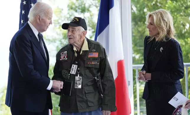 President Joe Biden and first lady Jill Biden, greet a World War II veteran during ceremonies to mark the 80th anniversary of D-Day, Thursday, June 6, 2024, in Normandy. (AP Photo/Evan Vucci)