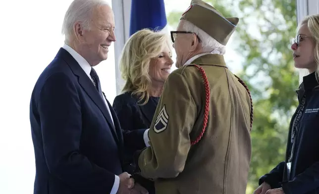 President Joe Biden and first lady Jill Biden, greet a World War II veteran during ceremonies to mark the 80th anniversary of D-Day, Thursday, June 6, 2024, in Normandy. (AP Photo/Evan Vucci)