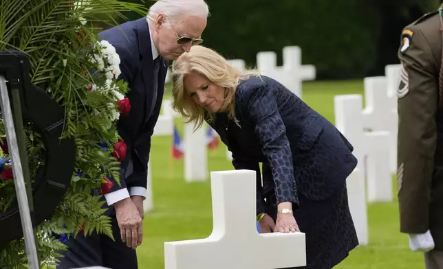 President Joe Biden and first lady Jill Biden walk in the Normandy American Cemetery following a ceremony to mark the 80th anniversary of D-Day, Thursday, June 6, 2024, in Normandy. (AP Photo/Evan Vucci)