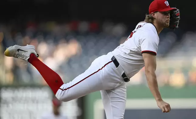 Washington Nationals starting pitcher Jake Irvin watches a throw to an Arizona Diamondbacks batter during the first inning of a baseball game Tuesday, June 18, 2024, in Washington. (AP Photo/John McDonnell)