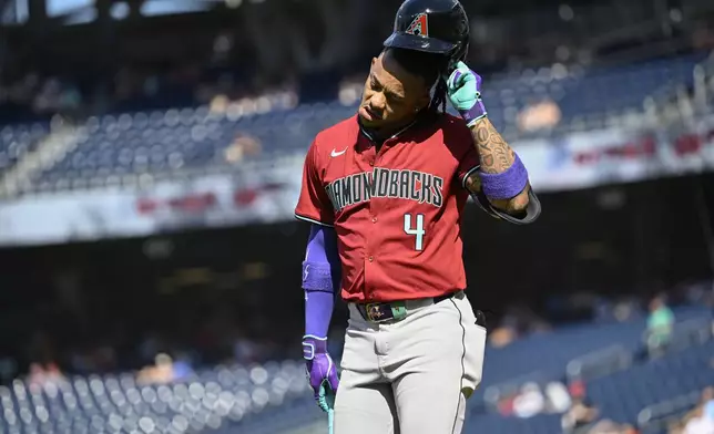 Arizona Diamondbacks's Ketel Marte walks back to the dugout after striking out during the third inning of a baseball game against the Washington Nationals Wednesday, June 19, 2024, in Washington. (AP Photo/John McDonnell)