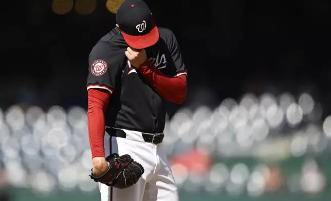Washington Nationals starting pitcher Patrick Corbin wipes away the sweat after walking in a run during the fourth inning of a baseball game against the Arizona Diamondbacks, Wednesday, June 19, 2024, in Washington. (AP Photo/John McDonnell)