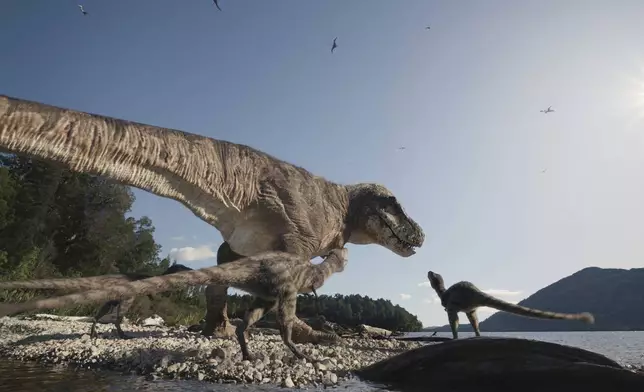 This image provided by Giant Screen Films and taken from the film "T.REX,” shows a mother T. rex and her young. (Courtesy of Giant Screen Films via AP)