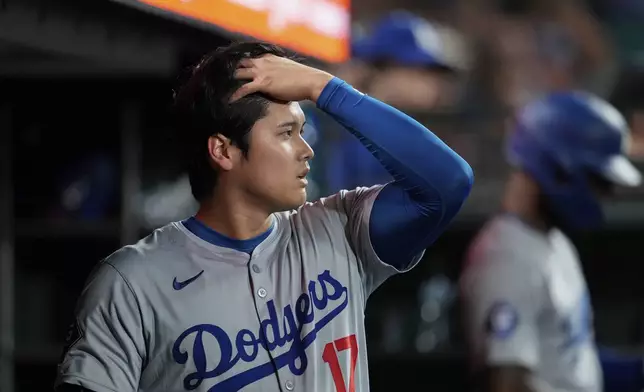Los Angeles Dodgers' Shohei Ohtani walks through the dugout during the eighth inning of the team's baseball game against the San Francisco Giants, Friday, June 28, 2024, in San Francisco. (AP Photo/Godofredo A. Vásquez)