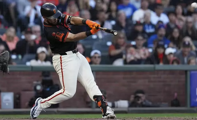 San Francisco Giants' David Villar hits an RBI double against the Los Angeles Dodgers during the 10th inning of a baseball game Saturday, June 29, 2024, in San Francisco. (AP Photo/Godofredo A. Vásquez)