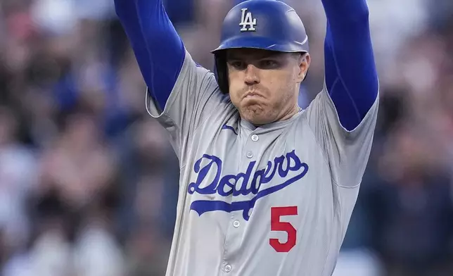 Los Angeles Dodgers' Freddie Freeman celebrates his RBI double against the San Francisco Giants during the 11th inning of a baseball game Saturday, June 29, 2024, in San Francisco. (AP Photo/Godofredo A. Vásquez)