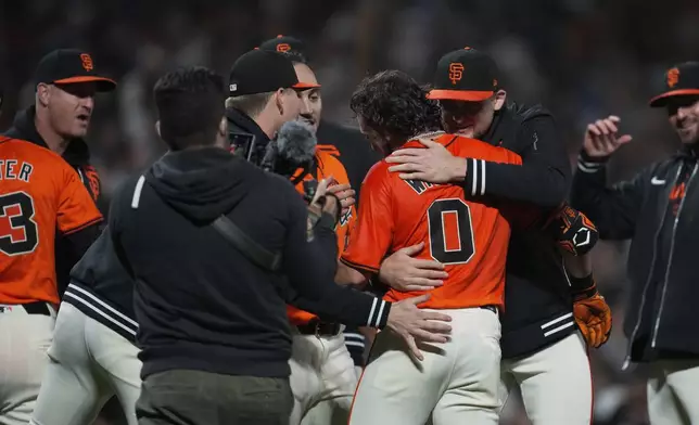San Francisco Giants' Brett Wisely (0) is congratulated after hitting a game-wining, two-run home run against the Los Angeles Dodgers during the ninth inning of a baseball game Friday, June 28, 2024, in San Francisco. (AP Photo/Godofredo A. Vásquez)